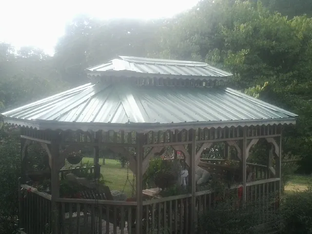 Two tier green metal roof on a garden gazebo in Hunker